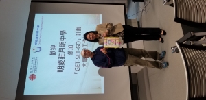 Ms Michele Hu, Director of Public Affairs Office, presents a banner to Caritas Chong Yuet Ming Secondary School